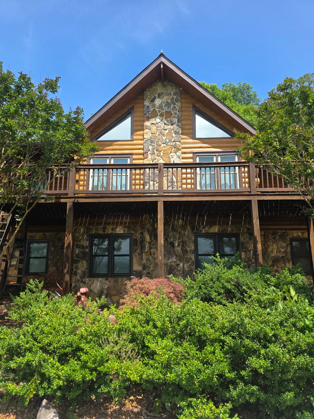 Restored log cabin on a wooded hillside